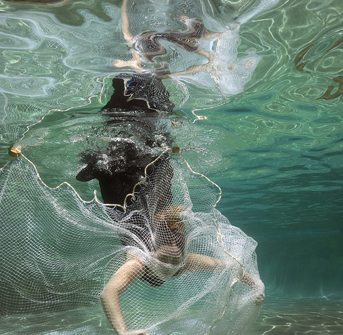 Image of Shelbey Leco diving into her grandfather's hand made trawling net